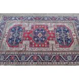 Anatolian rug with triple medallion design in shades of blue, claret and ivory, 177cms x 120cms