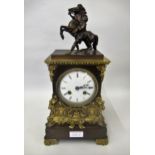 19th Century French gilt and bronze cased mantel clock surmounted with a small patinated Mali