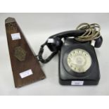 Mid 20th Century black Bakelite telephone, together with a French walnut cased metronome by Paquet