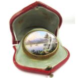 19th Century oval gold and mounted painted enamel brooch depicting lake scene, with steam and