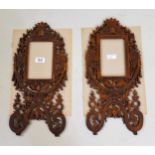 Pair of Asian carved and pierced frames decorated with foliage and birds mounted on card with some