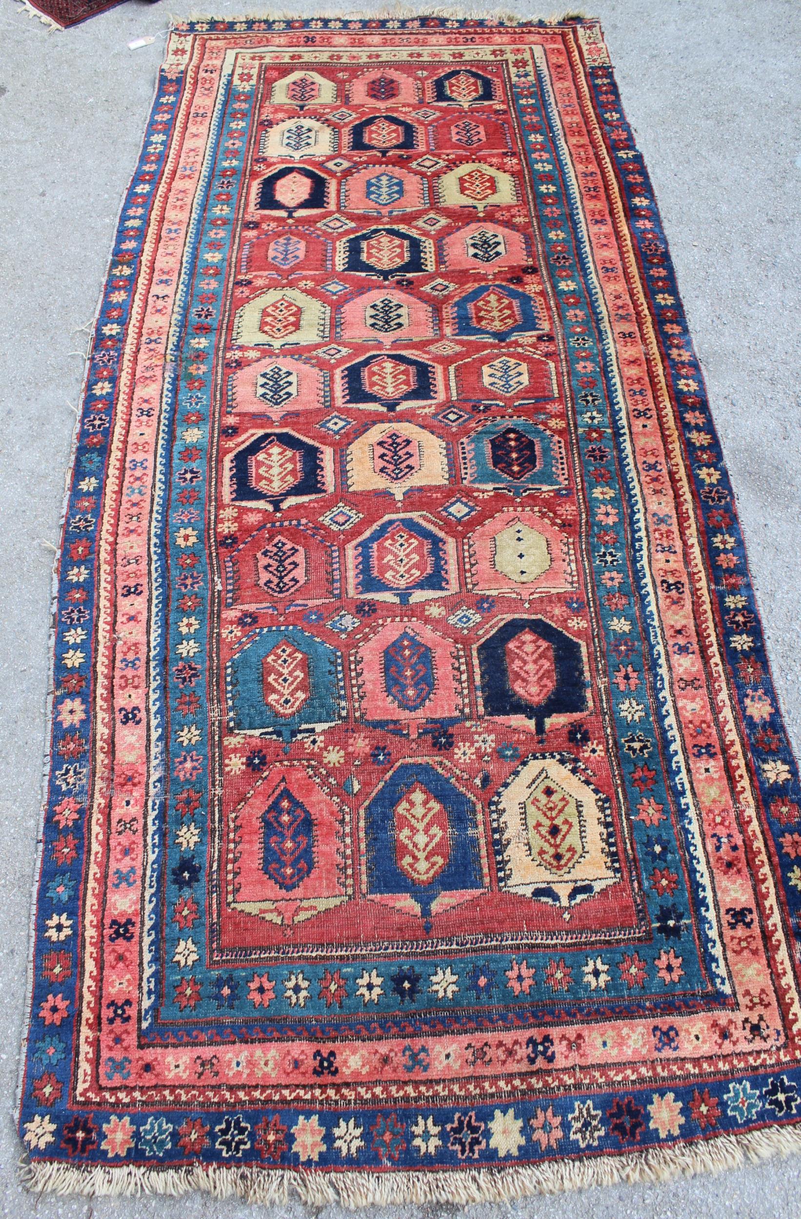 Kazak runner with an all-over stylised design on a brick red ground with borders, 250cms x 108cms - Image 2 of 5