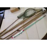 Two early 20th Century split cane fishing rods, a landing net and various reels and fishing