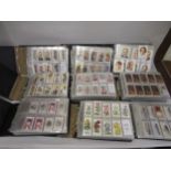 Two boxes containing nine albums of less common Wills cigarette cards