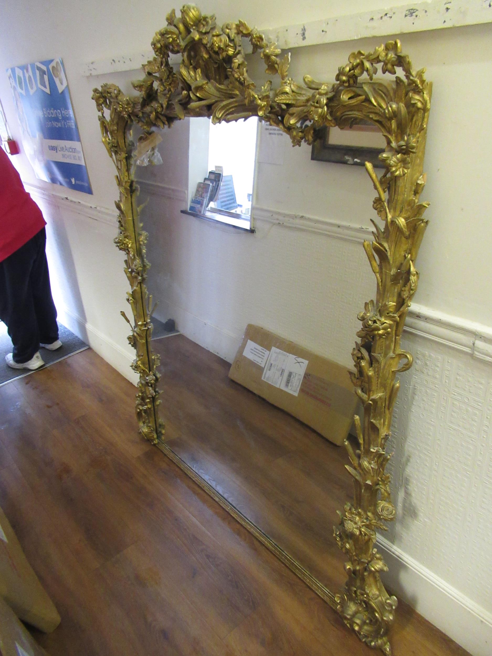 Large 19th Century French gilt composition wall mirror with floral pierced surmount and borders,