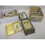 Two boxes containing a collection of postcards including an album, various cigarette cards and a box