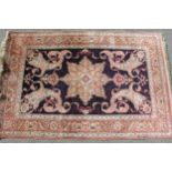Small modern Turkish silk style rug with a medallion and Boteh design on a midnight blue ground with