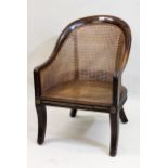 19th Century beechwood tub-shaped bergere armchair on sabre front supports, 79cms high x 54cms