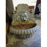 Patinated iron garden fountain, cast with a lions head In good condition, no cracks or repairs.