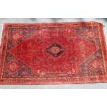 Qashqai rug with medallion and all-over design on red ground with corner designs and borders, (