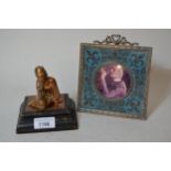 Small copper figure of a seated boy on a wooden base, together with a metal mirror frame and another