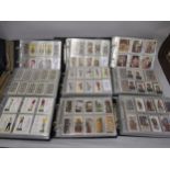 Nine albums containing a quantity of less common Players cigarette cards in two boxes