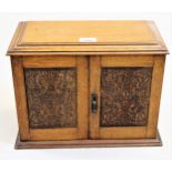 Early 20th Century oak smoker's cabinet with a hinged cover and two doors enclosing a fitted