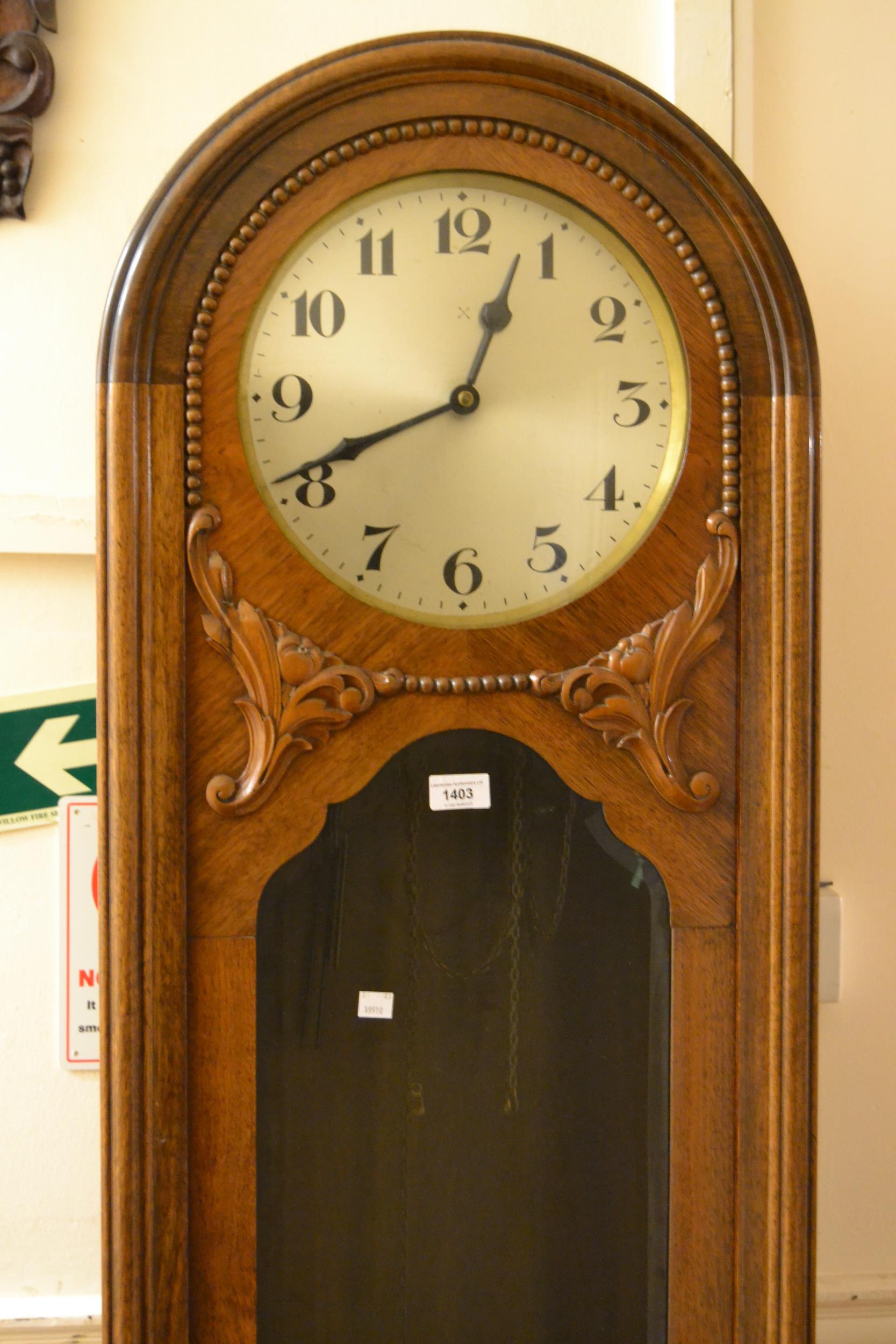 Early 20th Century walnut longcase clock, the circular silvered dial with Arabic numerals and