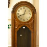 Early 20th Century walnut longcase clock, the circular silvered dial with Arabic numerals and