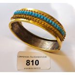 Victorian gilt metal and turquoise set bangle, the internal measurements approximately 55mm x