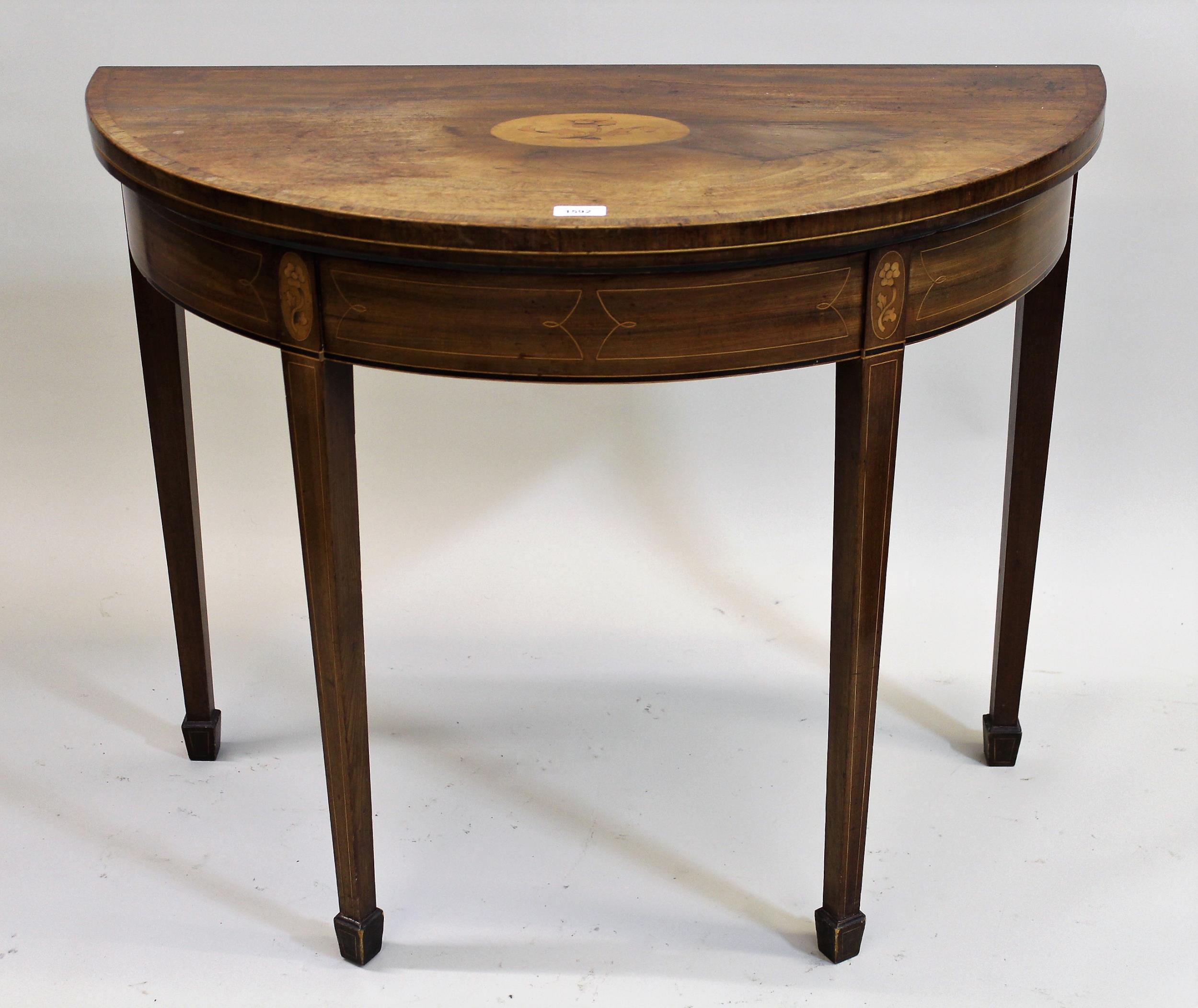 George III mahogany and inlaid demi lune card table, the fold-over top enclosing a baize lined