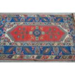 Modern Turkish rug with a medallion and floral design centre panel, blue ground borders and twin