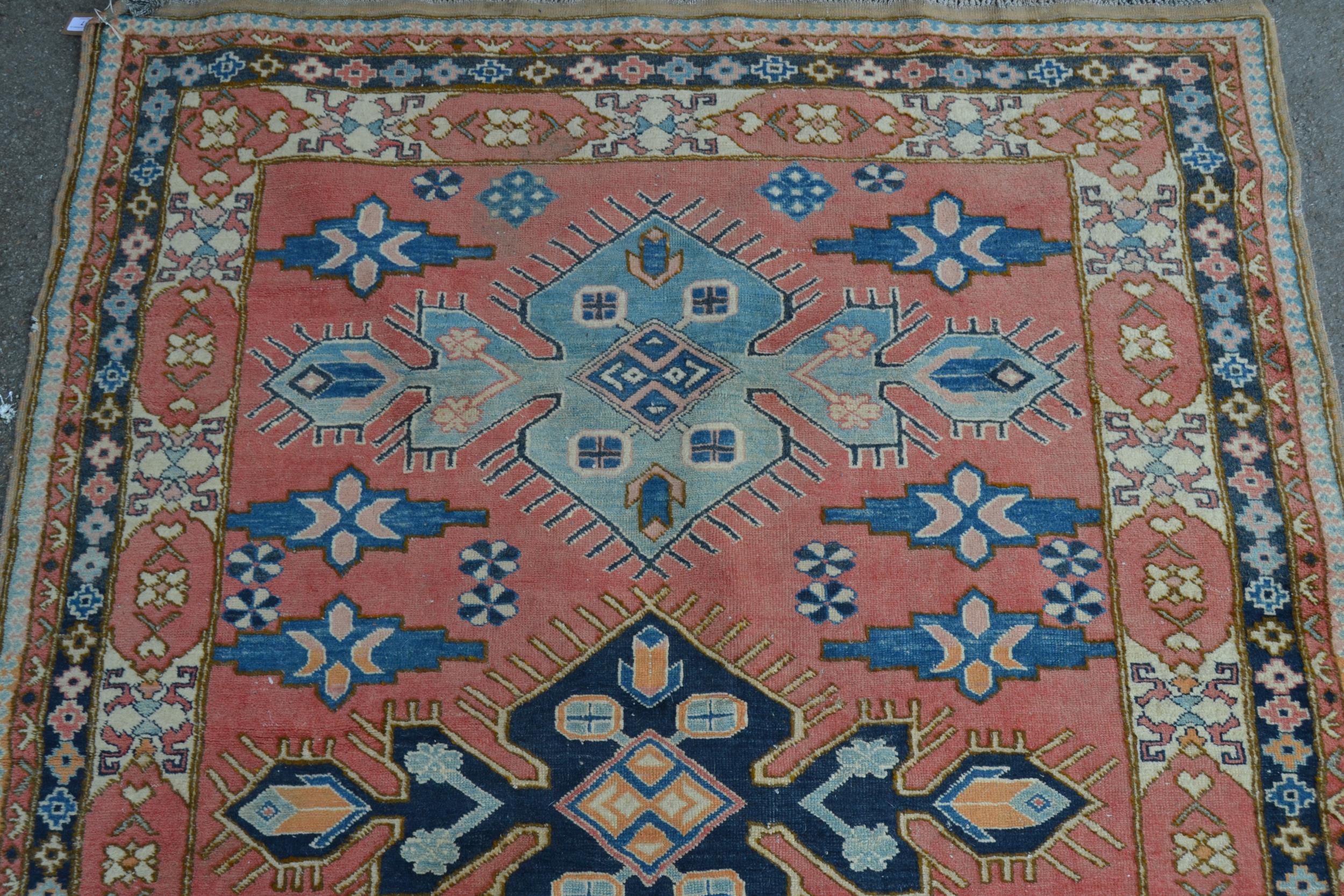 Turkish rug of Caucasian design with triple medallion on a rose ground with borders, 184cms x 145cms - Image 2 of 4