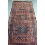 Afghan Belouch rug with a triple medallion and all-over stylised design on a rust ground with