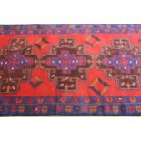 Modern Belouch rug with a twin medallion design in shades of dark blue and red, 190cms x 115cms (