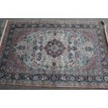 Modern Qum style rug with a medallion and all-over floral and vase design on ivory ground with