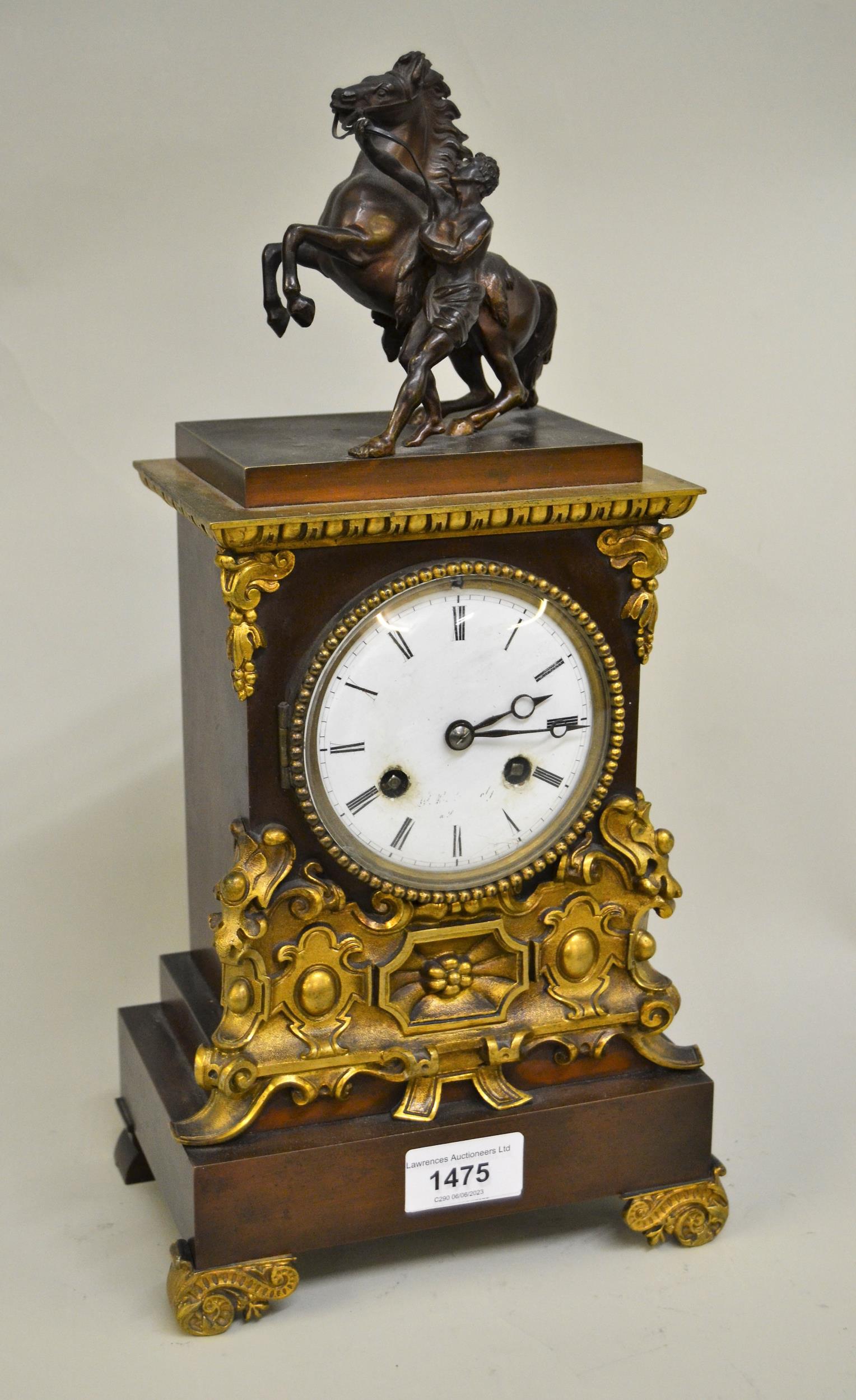 19th Century French gilt and dark patinated bronze cased mantel clock surmounted with a small