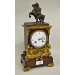 19th Century French gilt and dark patinated bronze cased mantel clock surmounted with a small