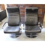 Pair of BO Concept black leather upholstered recliner chairs (one with slight damage to the