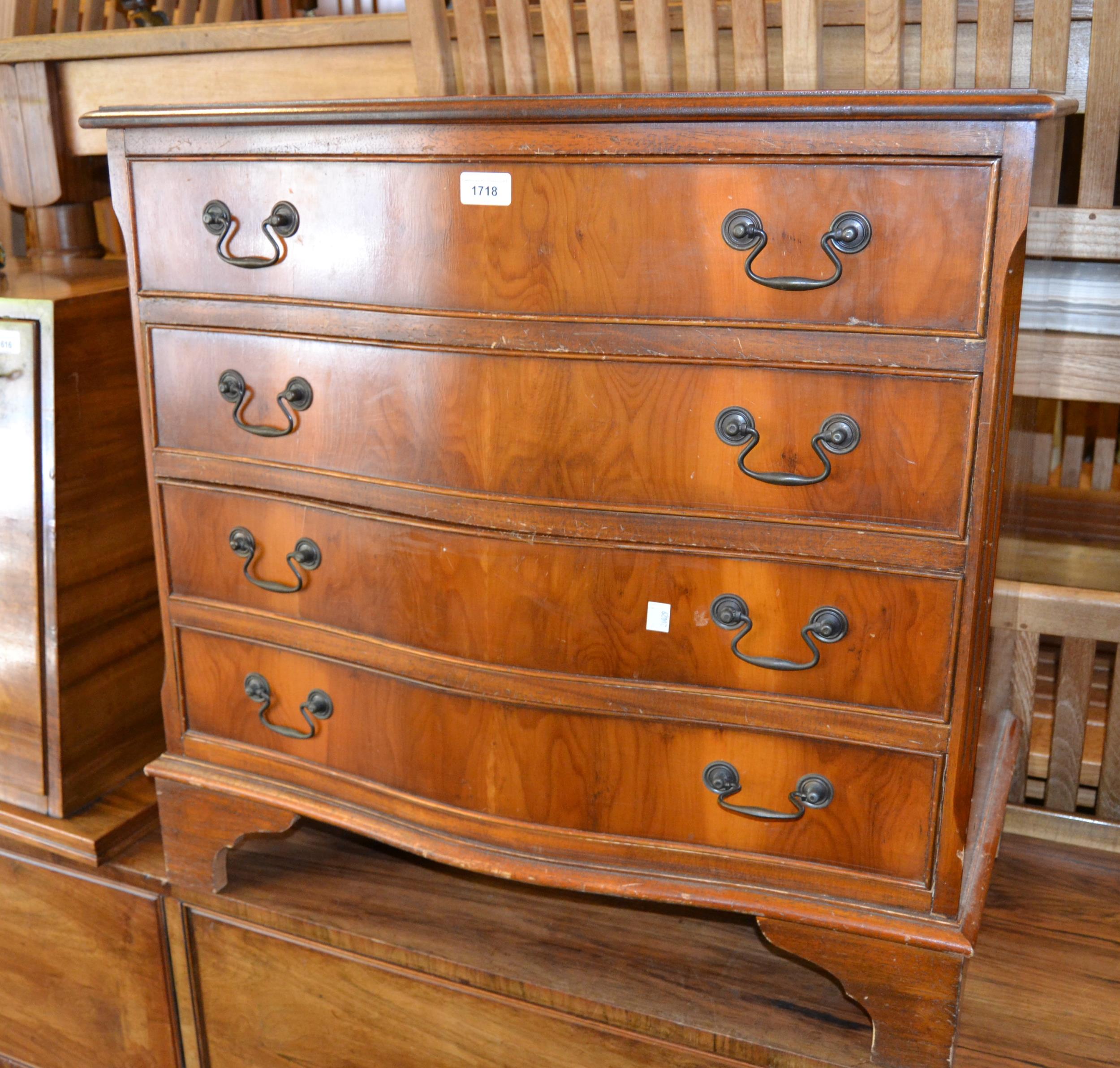 Reproduction yew wood four drawer serpentine shaped chest, together with a similar corner cabinet