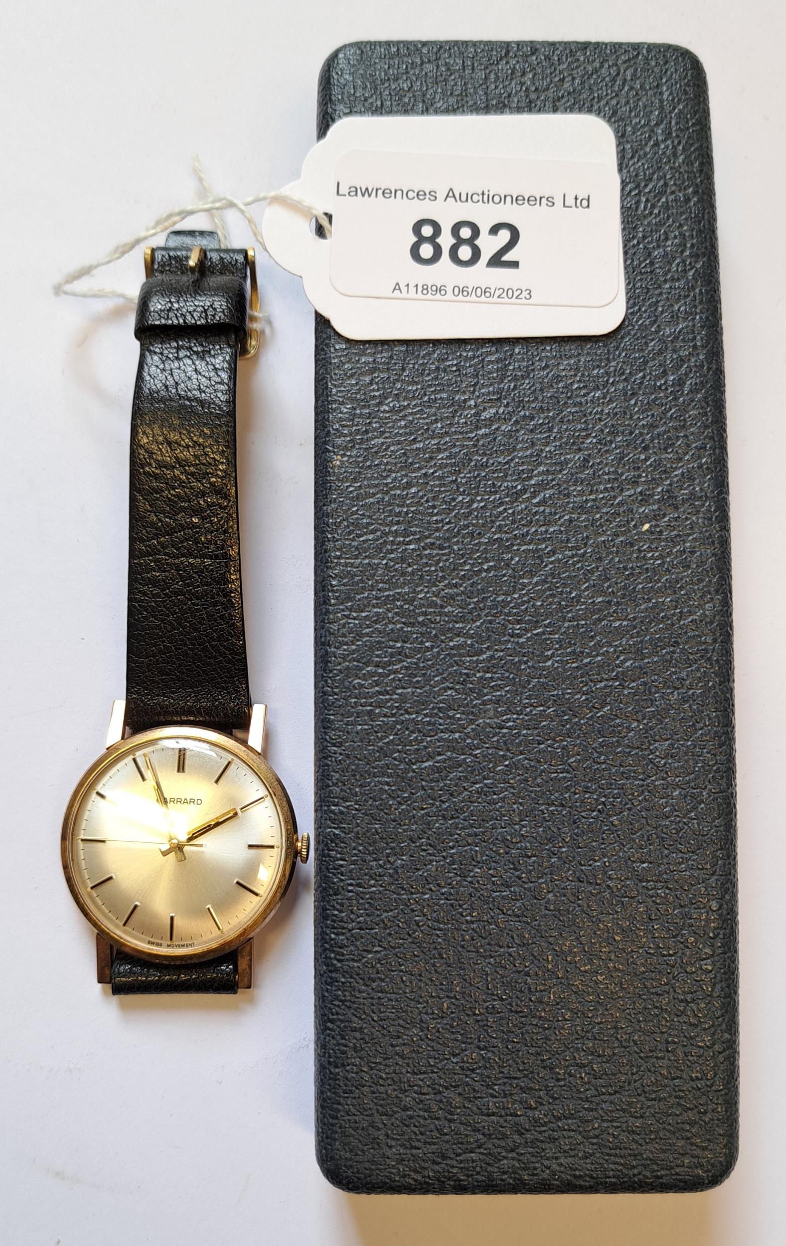 Garrard, gentleman's circular gold cased wristwatch with black leather strap, in original box