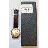 Garrard, gentleman's circular gold cased wristwatch with black leather strap, in original box