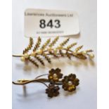 Small 15ct gold floral design brooch, together with a 9ct gold and pearl mounted floral brooch