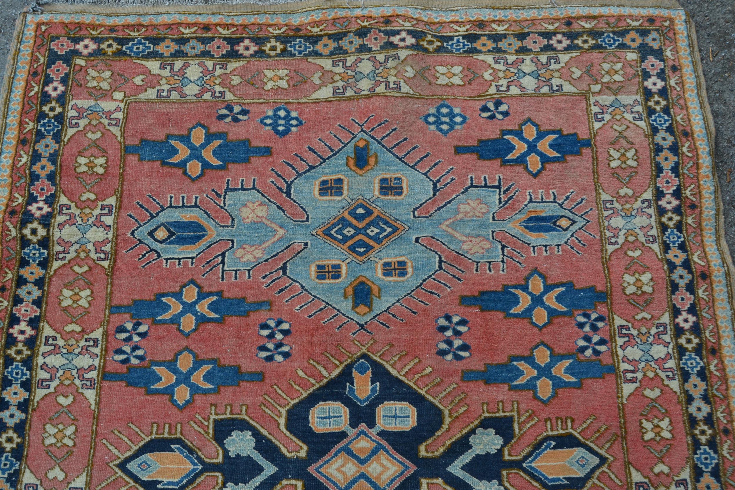 Turkish rug of Caucasian design with triple medallion on a rose ground with borders, 184cms x 145cms - Image 3 of 4