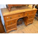 Mid 20th Century oak and walnut twin pedestal writing table, the leather inset top above six drawers