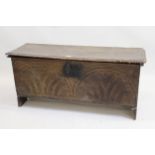 Antique plank coffer with a hinged cover above carved front, 114cms x 38cms x 52cms high