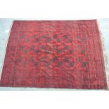 Afghan carpet with three rows of six gols on a wine red ground with borders, (some damages and