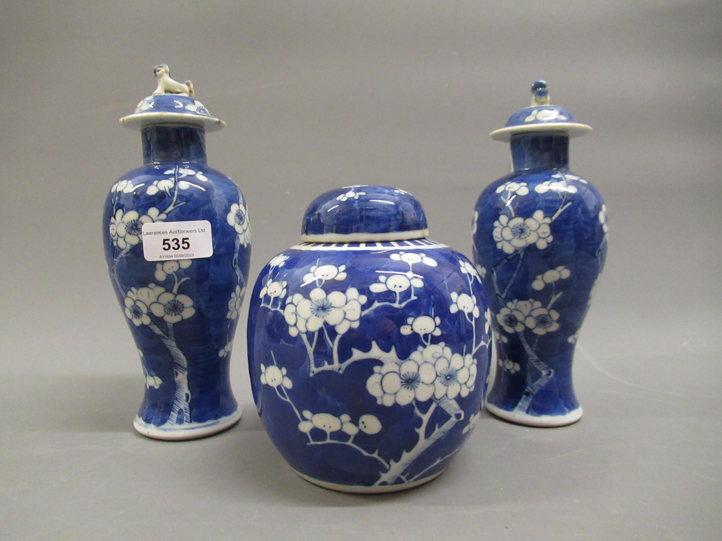 Pair of Chinese blue and white prunus blossom vases with covers, signed with four character marks to