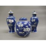 Pair of Chinese blue and white prunus blossom vases with covers, signed with four character marks to