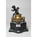 Reproduction dark patinated and gilt bronze figure of a cherub, on a shaped patinated metal plinth