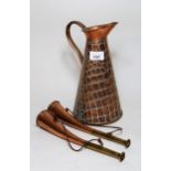 Copper jug by J.S. and S.B., together with two small copper and crass horns Height of jug 27cms