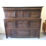 17th Century oak court cupboard, the canopy top above an arrangement of carved panels and doors, the