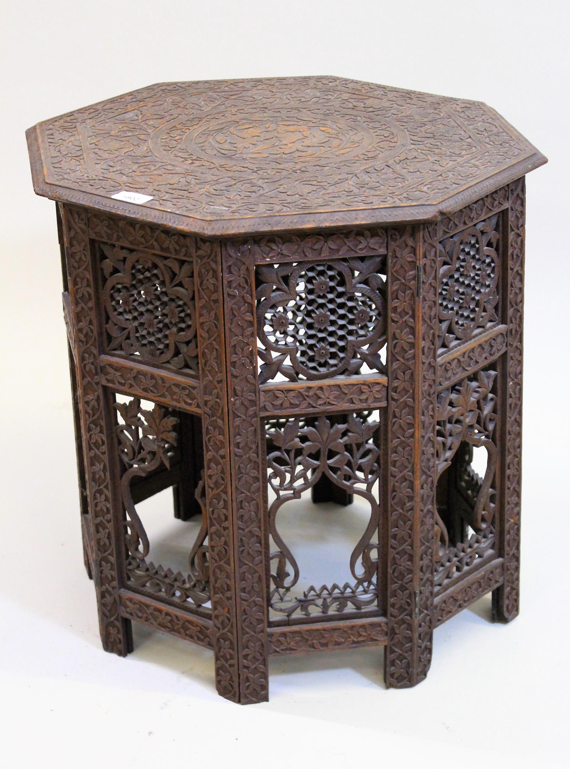 Indian octagonal carved hardwood occasional table, on a folding support Top is in good condition but