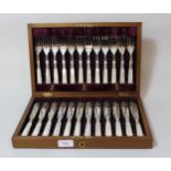 Mahogany cased set of twelve silver plated, mother of pearl handled fish knives and forks