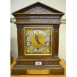 Late 19th Century oak cased bracket clock, the architectural case with brass dial, silvered