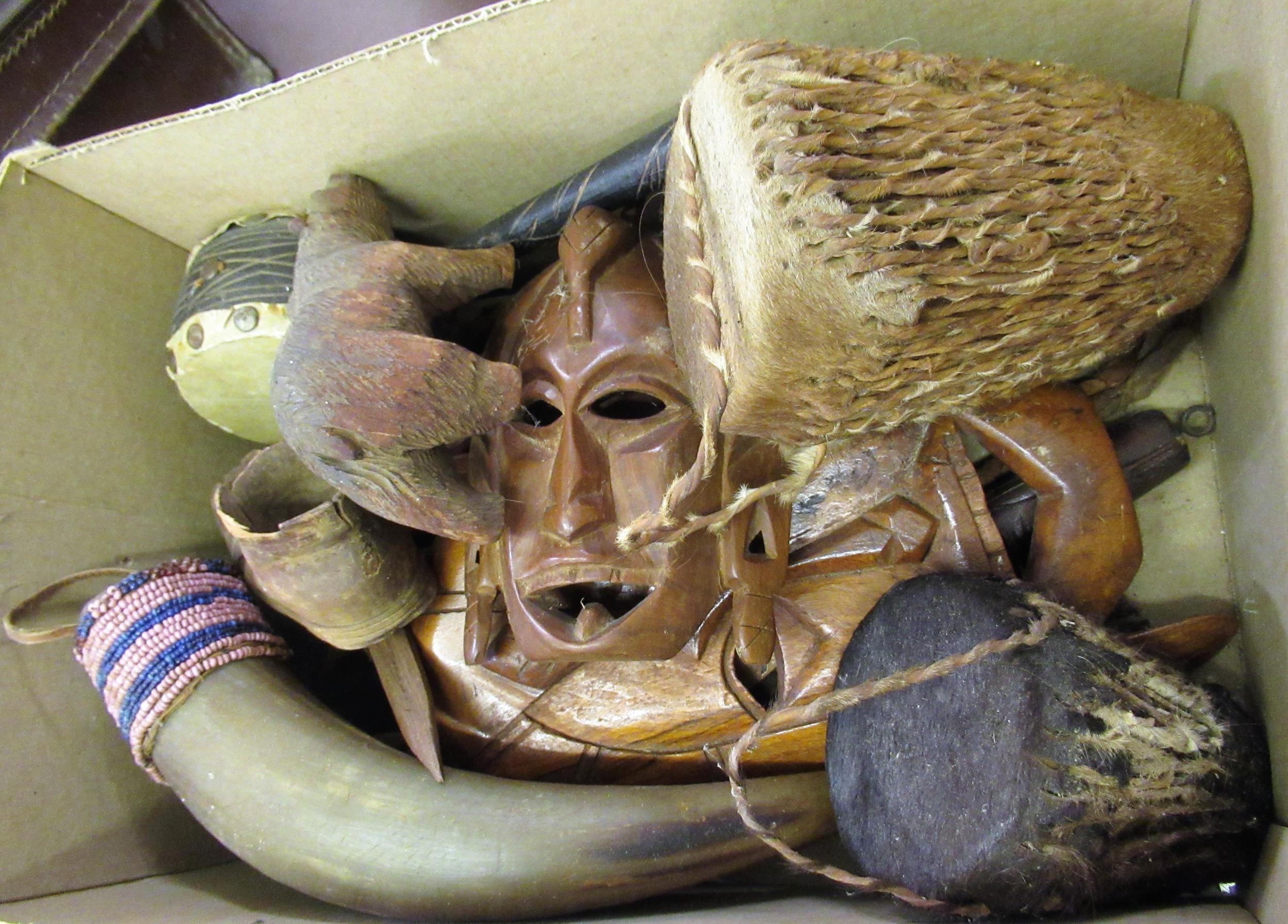 Box containing a small quantity of Native African miniature drums, masks and a small brown case