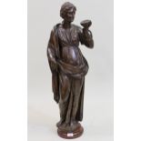 17th / 18th Century Continental carved oak figure of a standing classical female holding a cup,