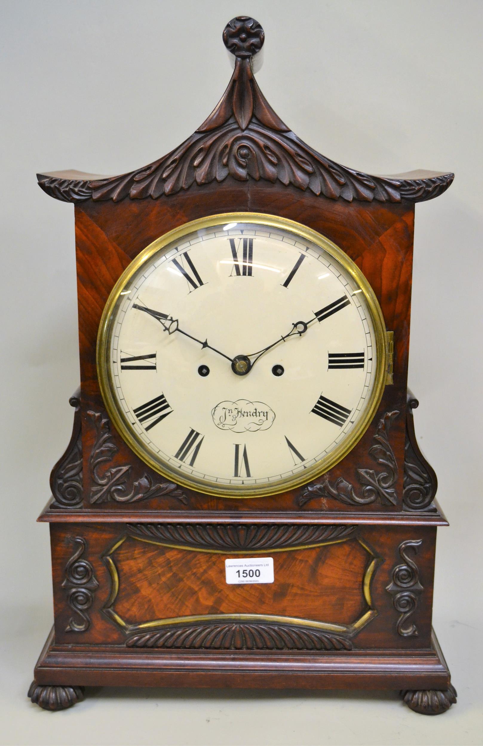 19th Century flame mahogany pagoda topped bracket clock having circular painted dial, with Roman