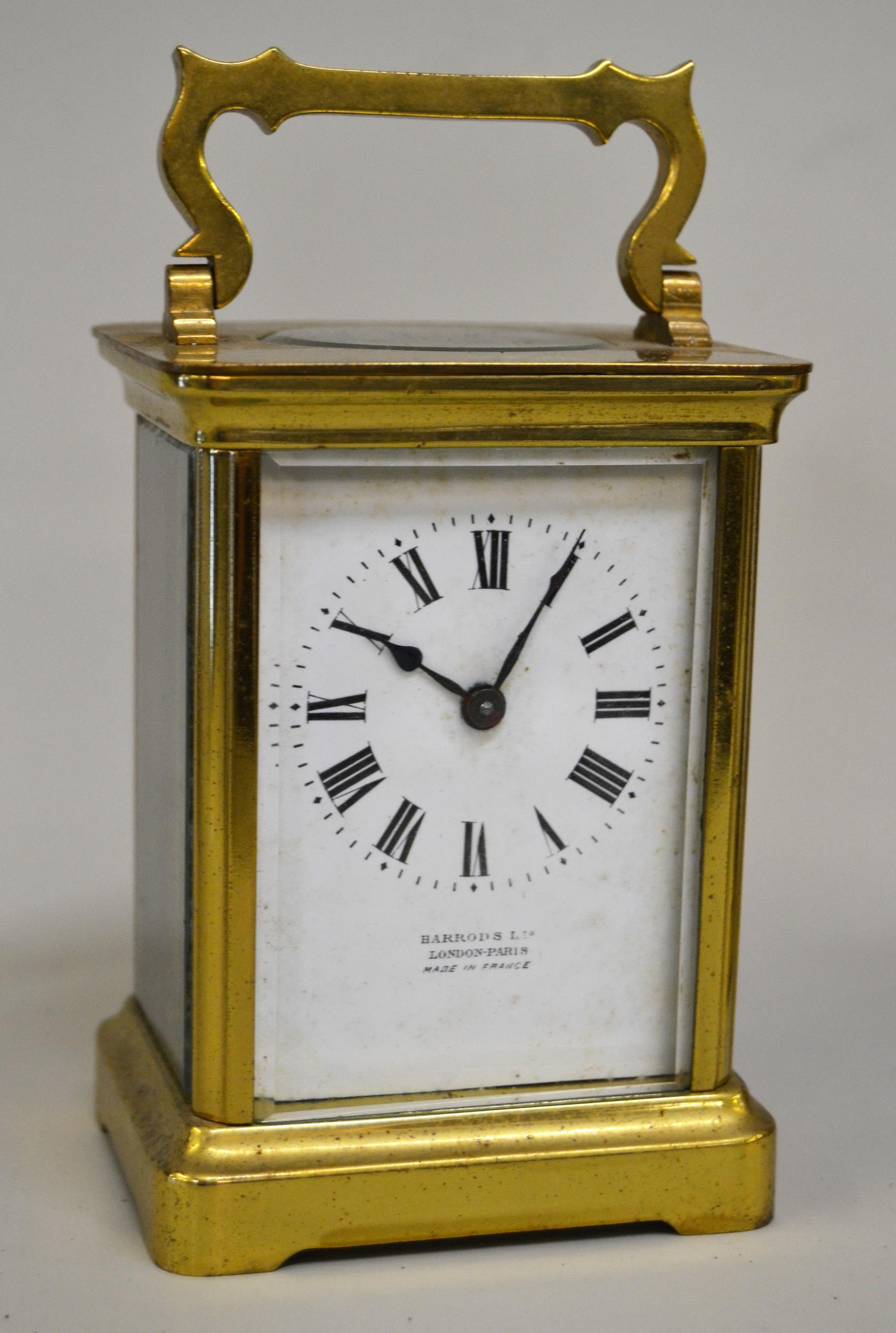 Small brass cased carriage clock, the enamel dial with Roman numerals, signed Barrods Ltd., with a