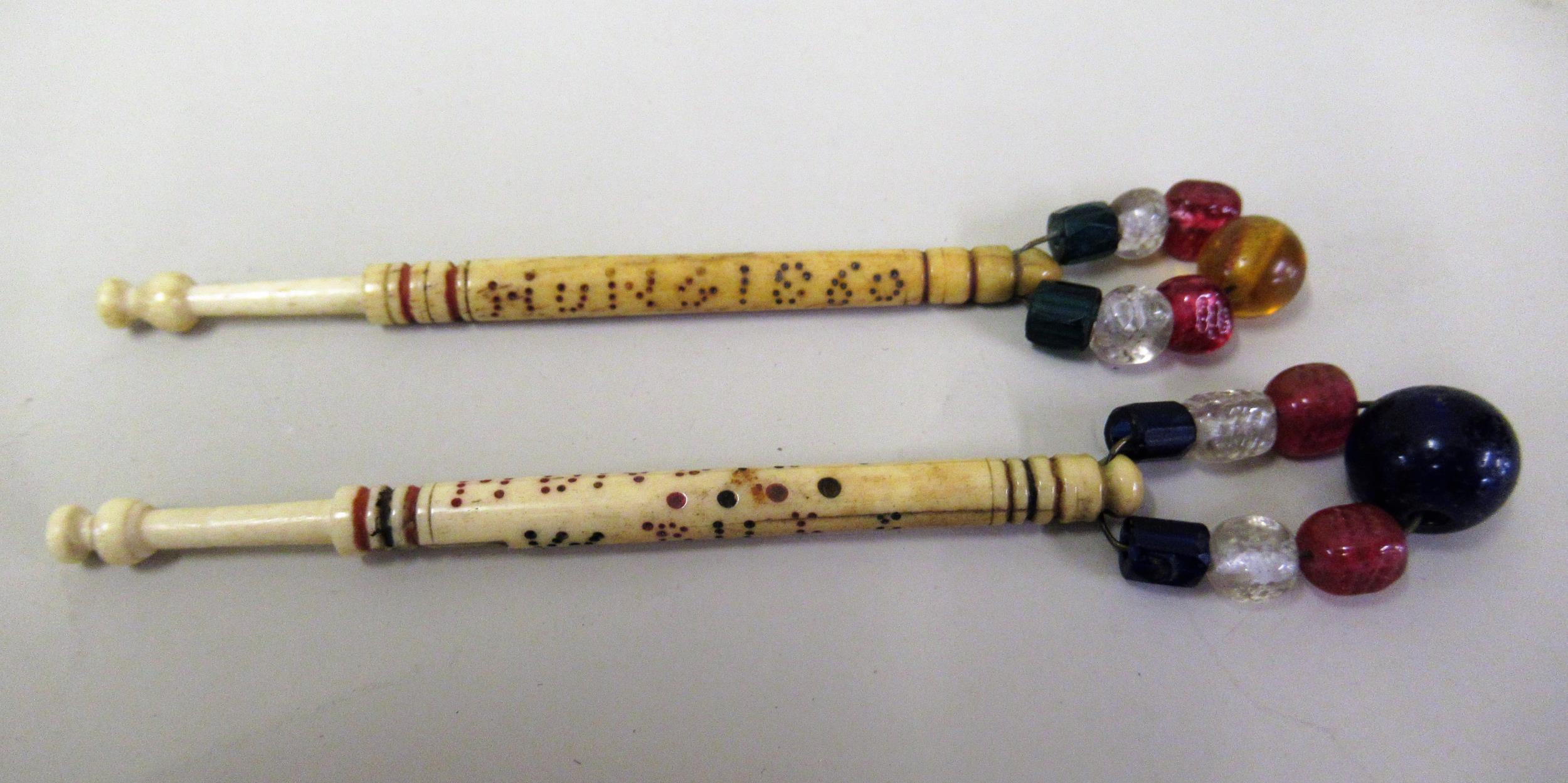 Two rare 19th Century bone lace makers hanging bobbins, inscribed W. Bull Hung, 1871 and Joseph